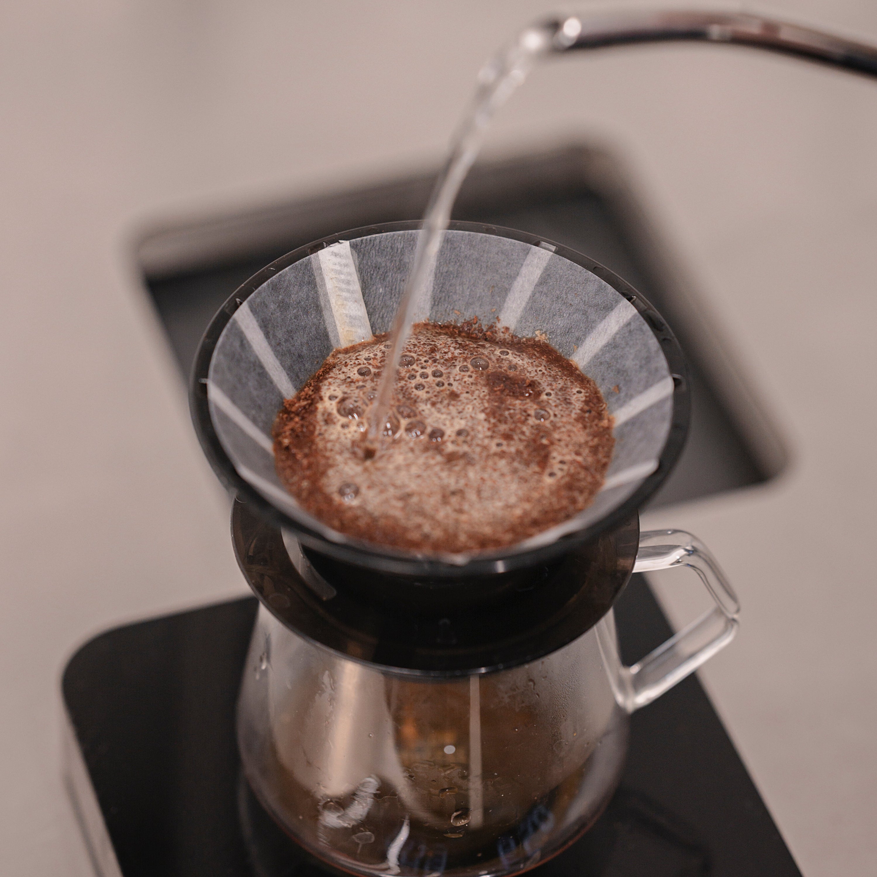Brewing a light-roast gesha with the UFO dripper and UFO filters during a busy shift